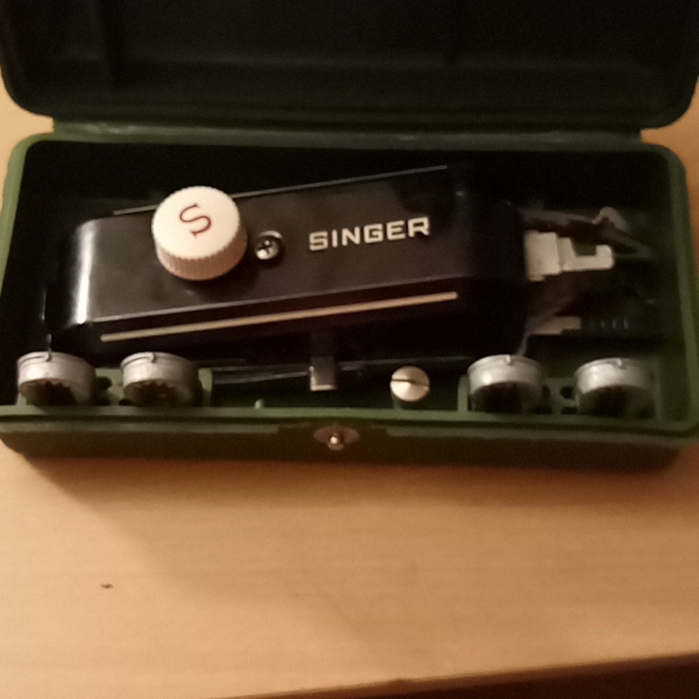 Singer hand held sewing machine with button attachment